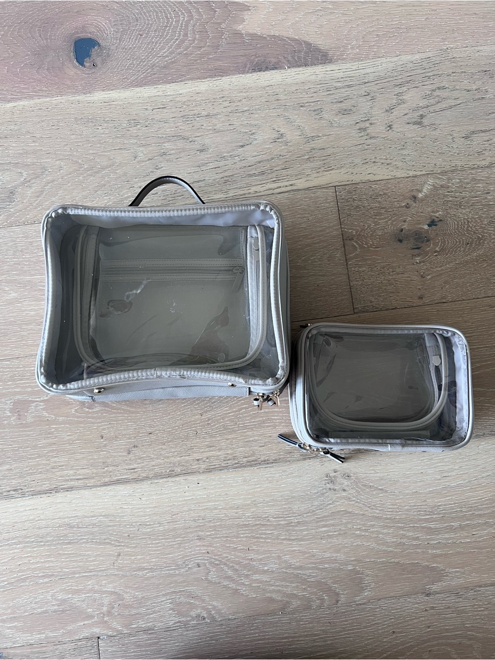Calpak Large and small clear cosmetic case in stone - Set of 2